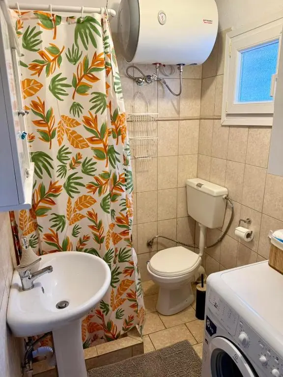Bathroom with shower and washing machine